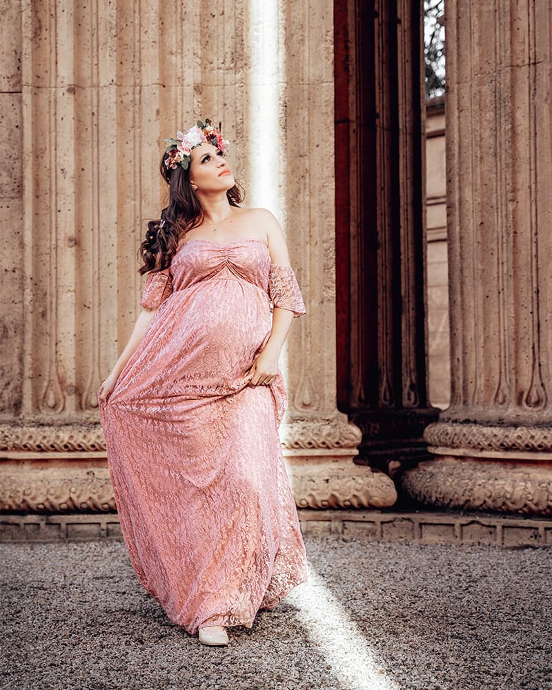 Expecting mother in a flowing dress during a golden hour maternity portrait session