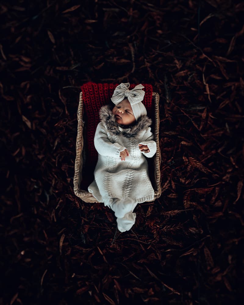 Newborn baby sleeping peacefully wrapped in a soft blanket — newborn portrait photography